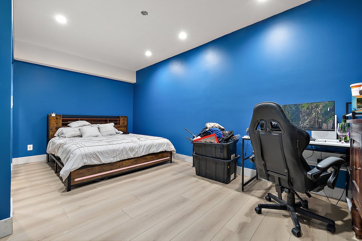 Finished blue room with clean walls and recessed lighting.